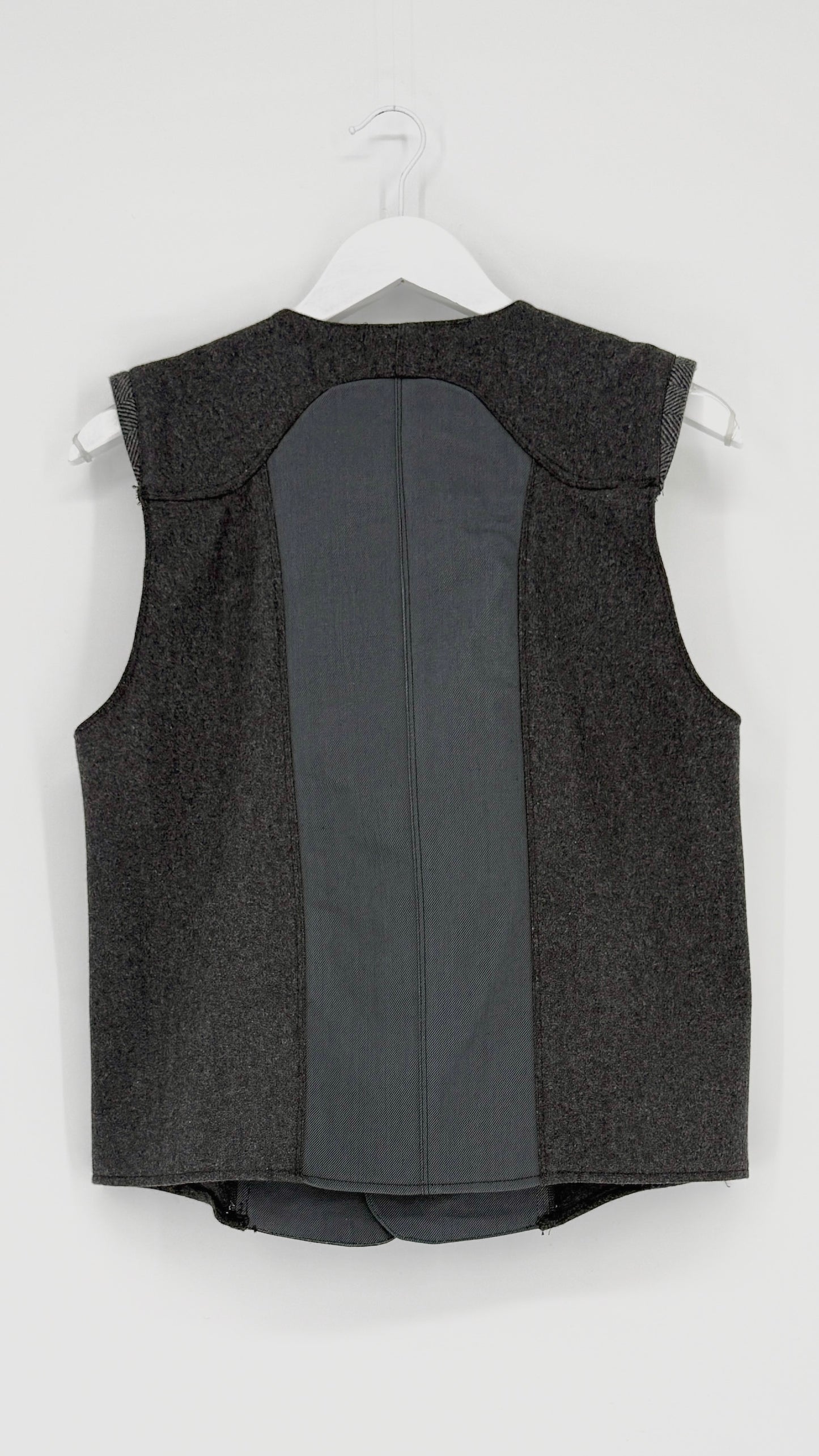 Gray vest on a white hanger against a white background