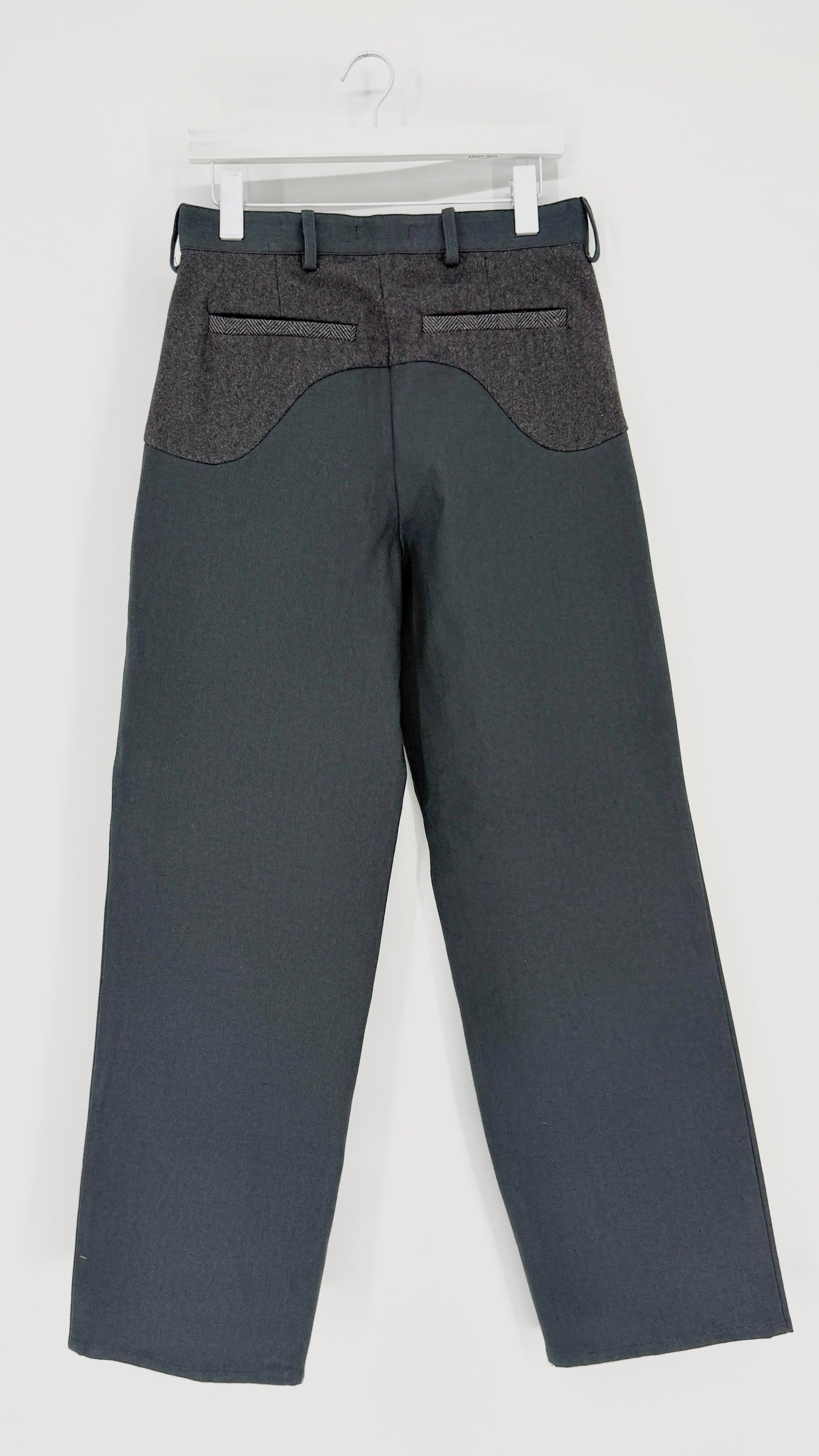 Gray pants on a hanger against a white background