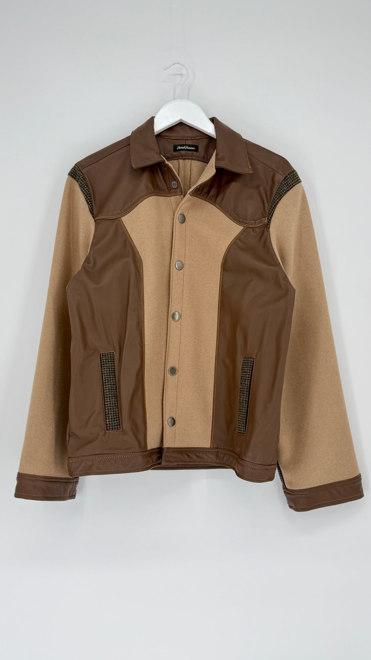Brown and beige jacket on a white hanger against a white background