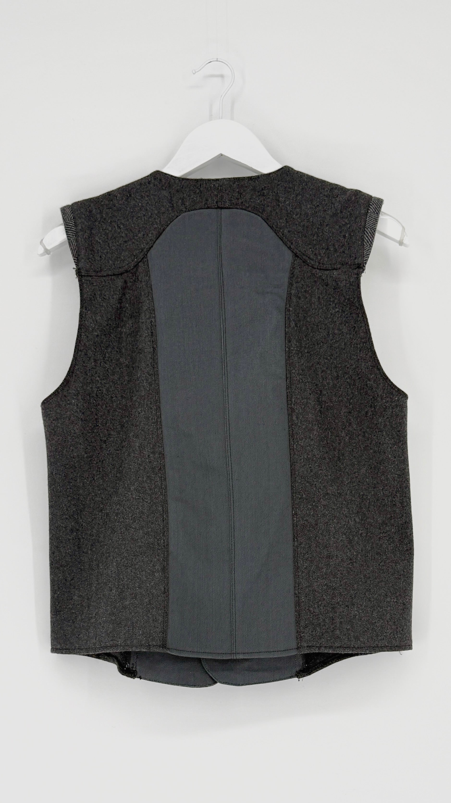 Gray vest on a white hanger against a white background
