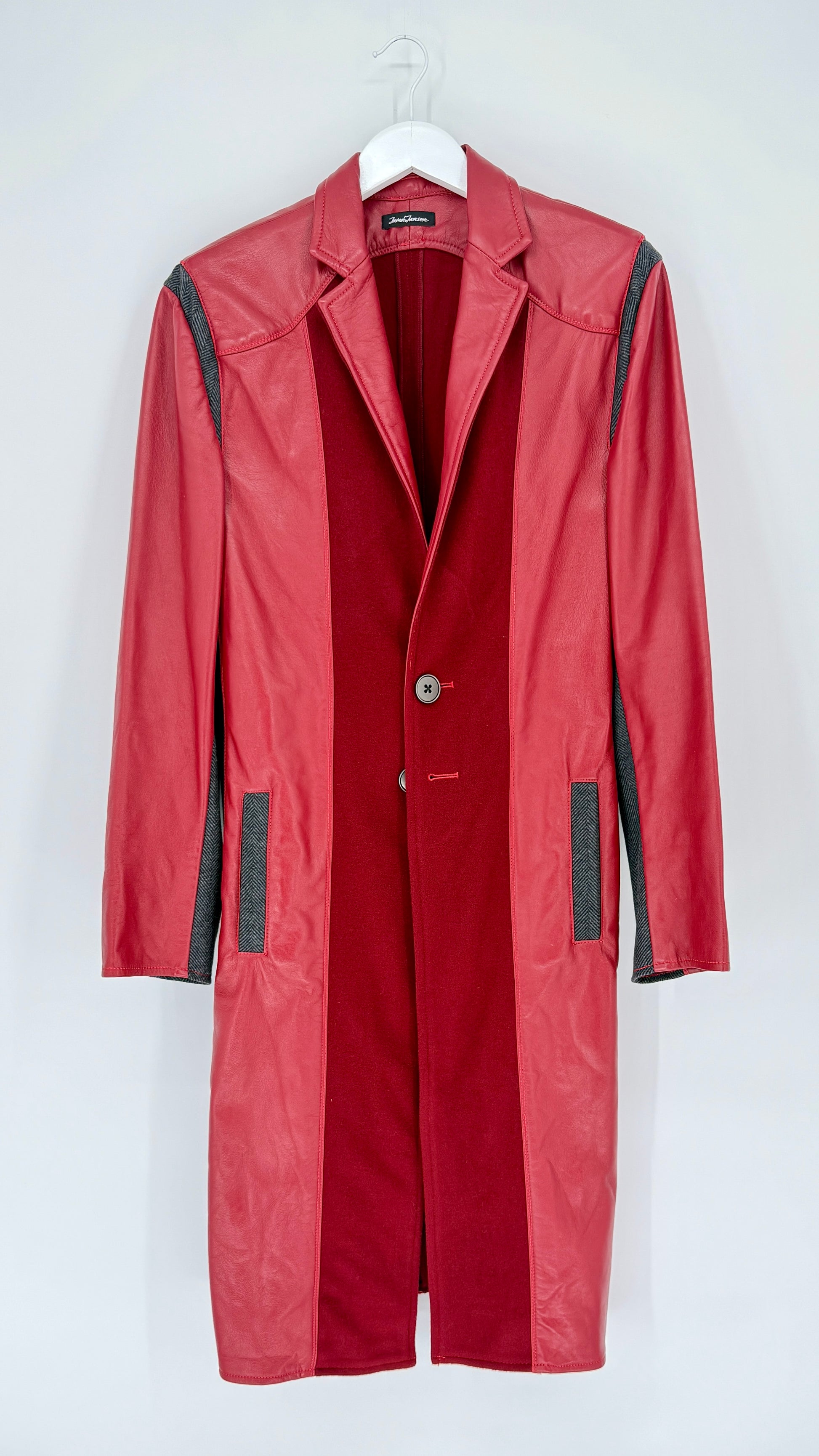 Red coat with black accents on a white hanger against a white background