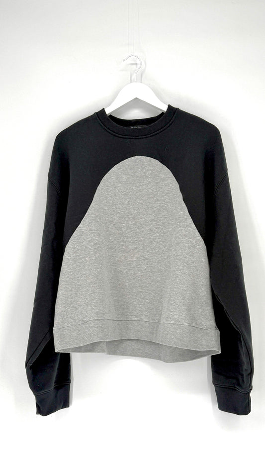 Black and gray sweatshirt on a hanger against a white background