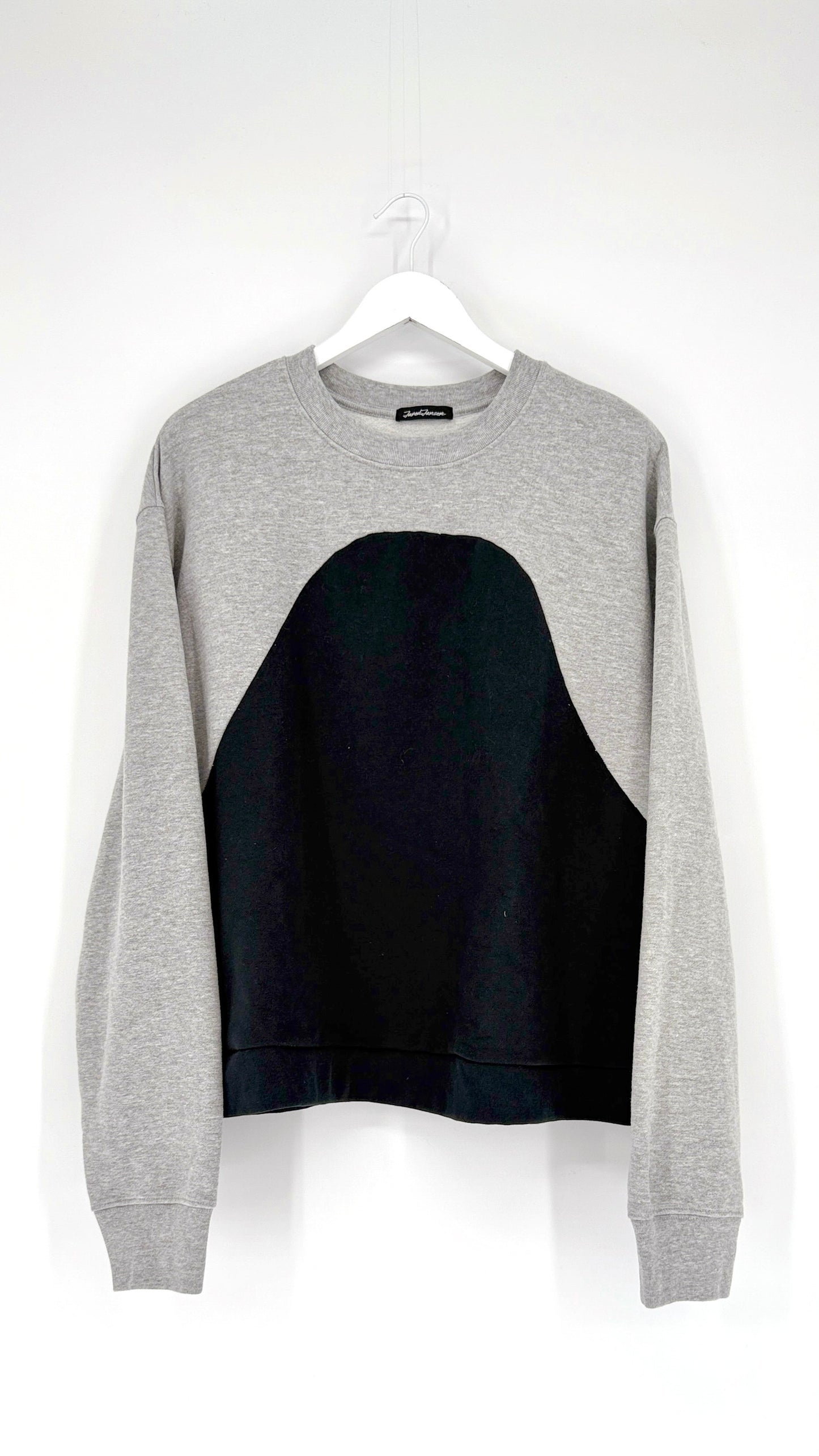 Gray sweatshirt with black panel on a white background