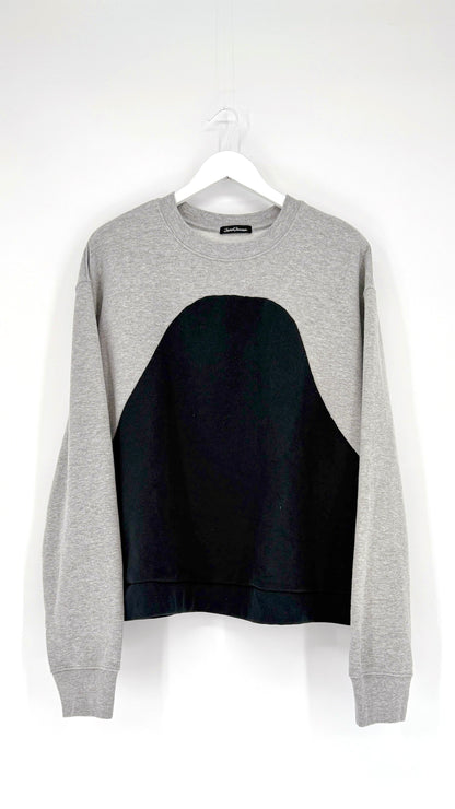 Gray sweatshirt with black panel on a white background