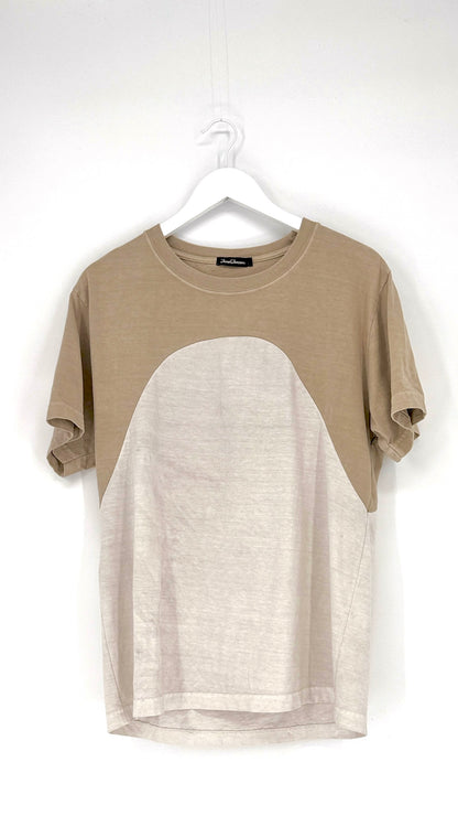 Two-tone t-shirt with beige and white design on a hanger against a white background