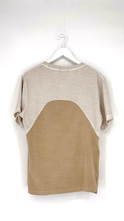 Two-tone shirt with beige and brown sections on a hanger against a white background