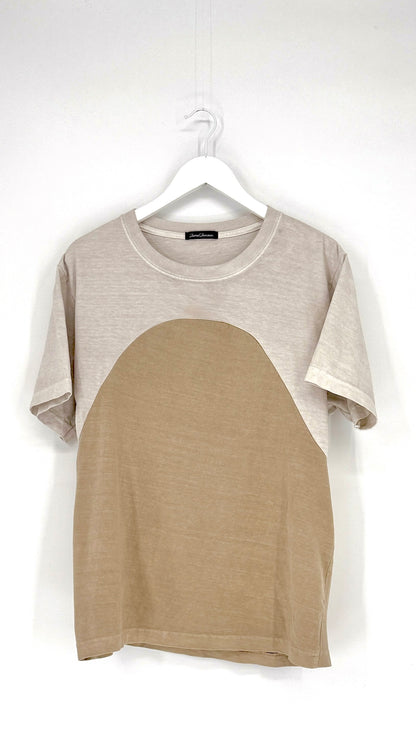 Two-tone t-shirt with gray sleeves and beige body on a hanger against a white background