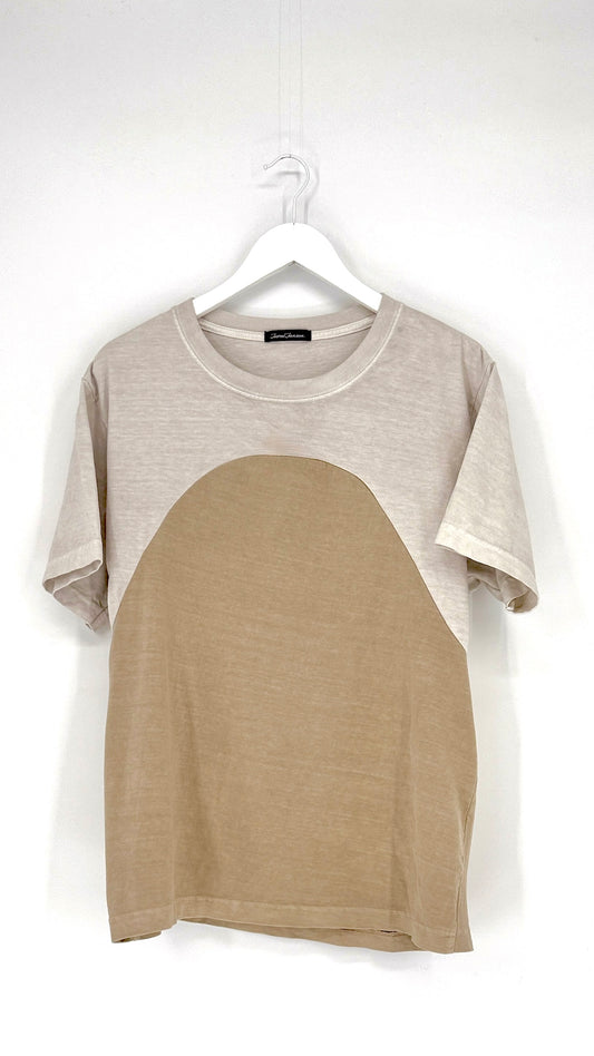 Two-tone t-shirt with gray sleeves and beige body on a hanger against a white background